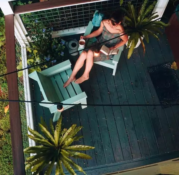 woman reading book on deck