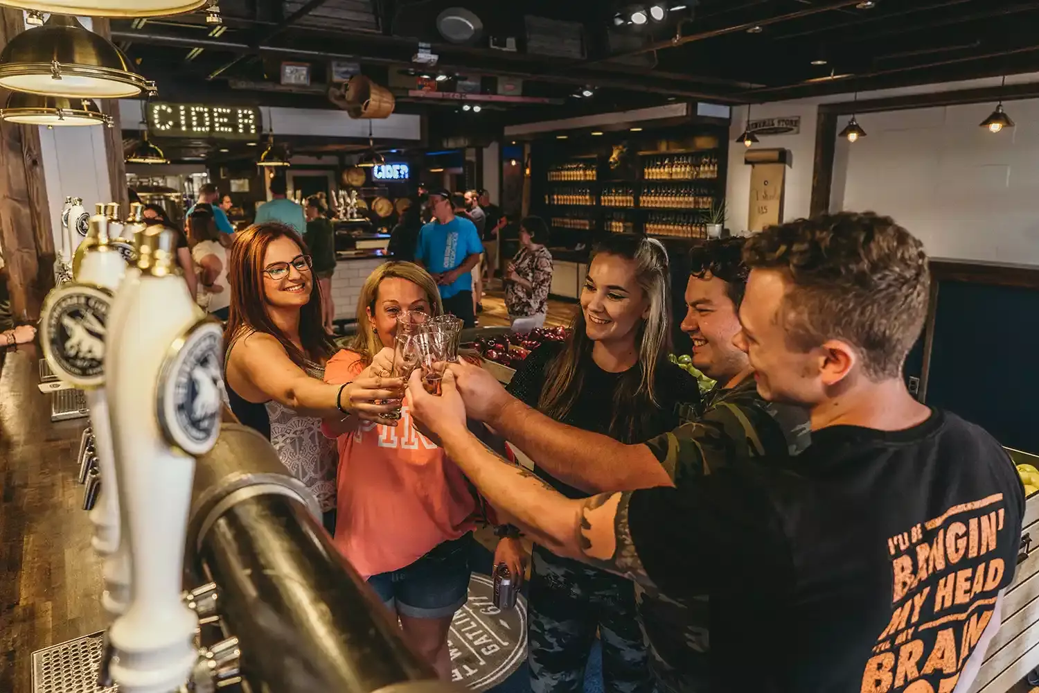 Friends enjoying free sips of hard cider at Tennessee Cider Company in Gatlinburg.