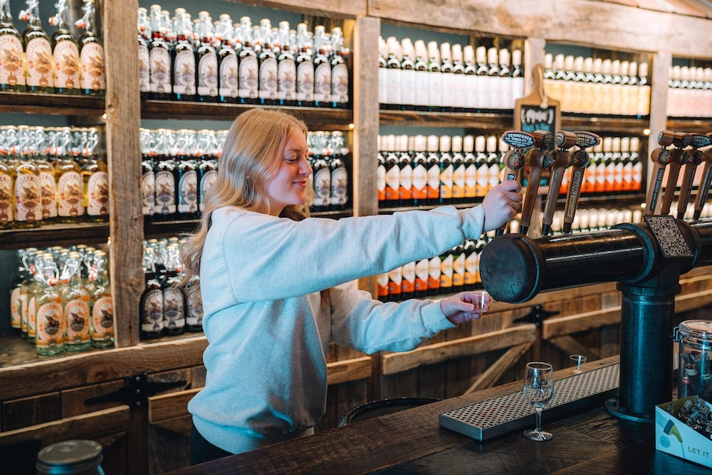 employee getting a wine sample for a visitor
